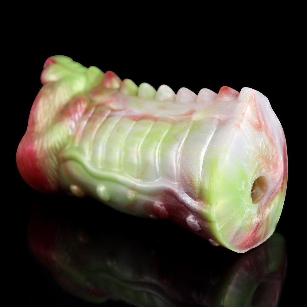 Fantasy dragon masturbator end view, white-and-green shaft with pink rim and side hole