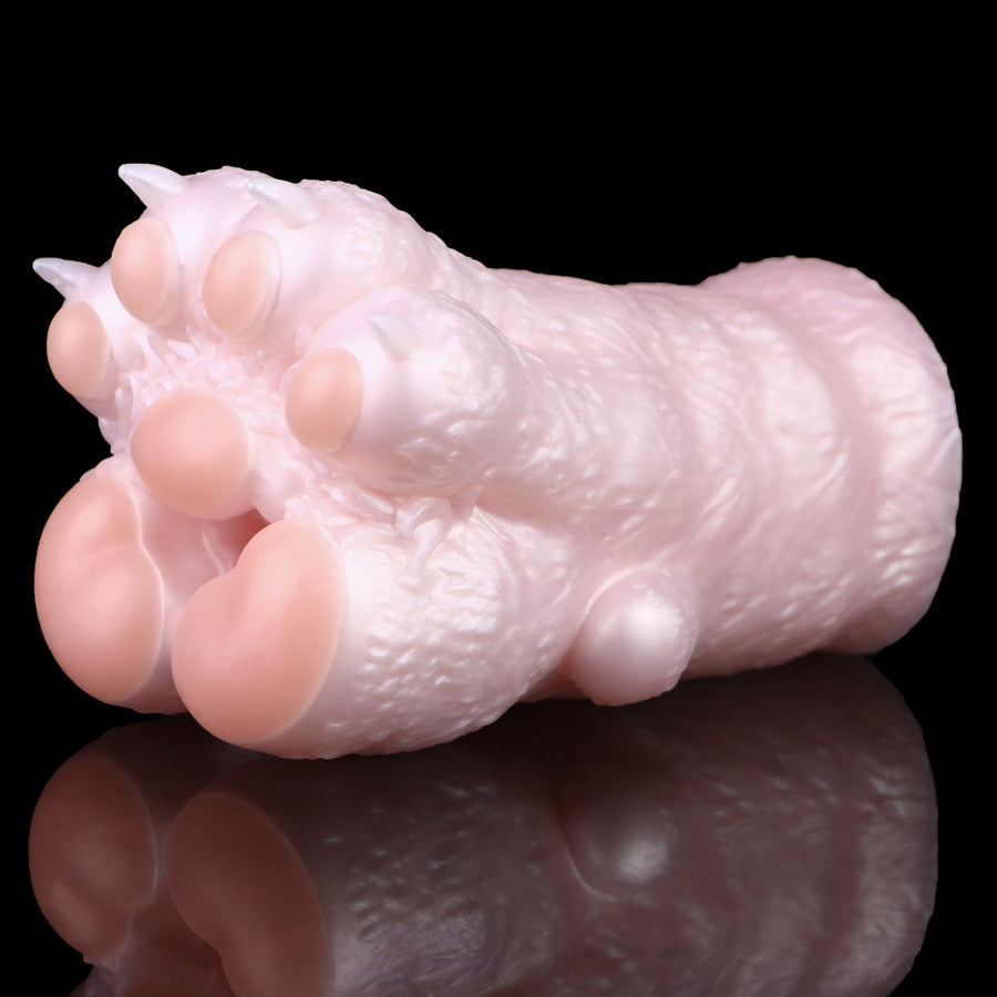 Cat paw-shaped stroker, pale pink, textured surface with five rounded toe pads on end.