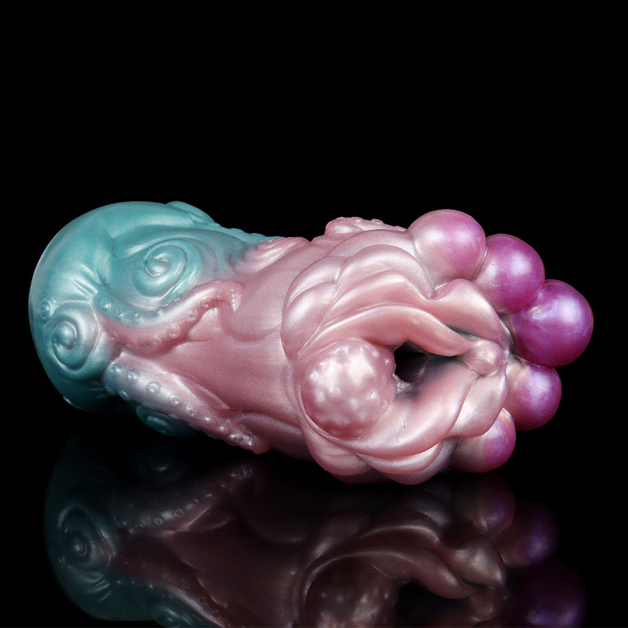 Novelty alien-style sex toy, teal and pink translucent with purple bulb end, side angle