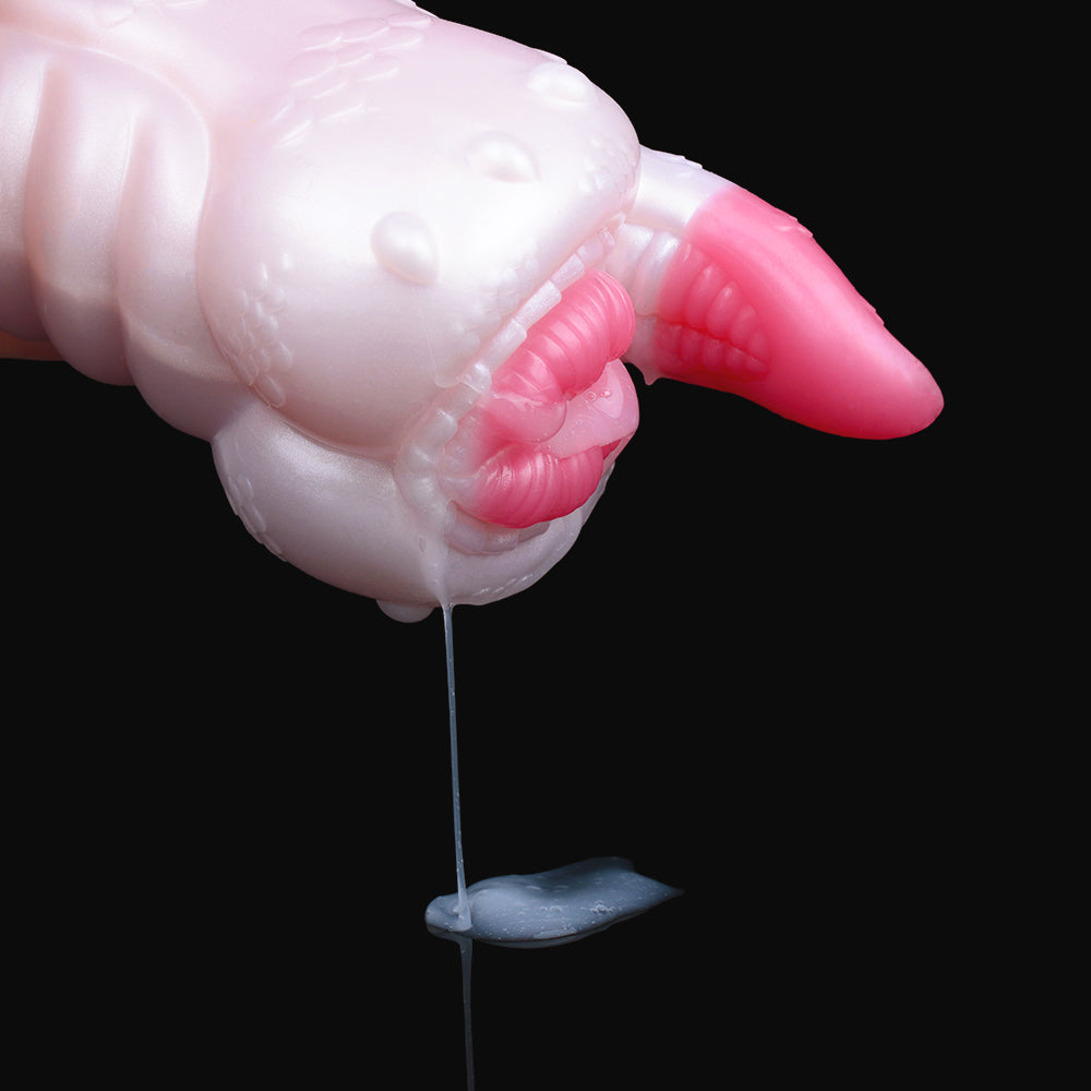 Dragon fleshlight close-up: pink horn and patterned grip with visible lubricant drip
