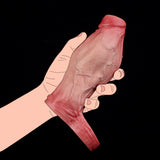 Hand holding pink realistic penis sleeve with knot, textured outer surface