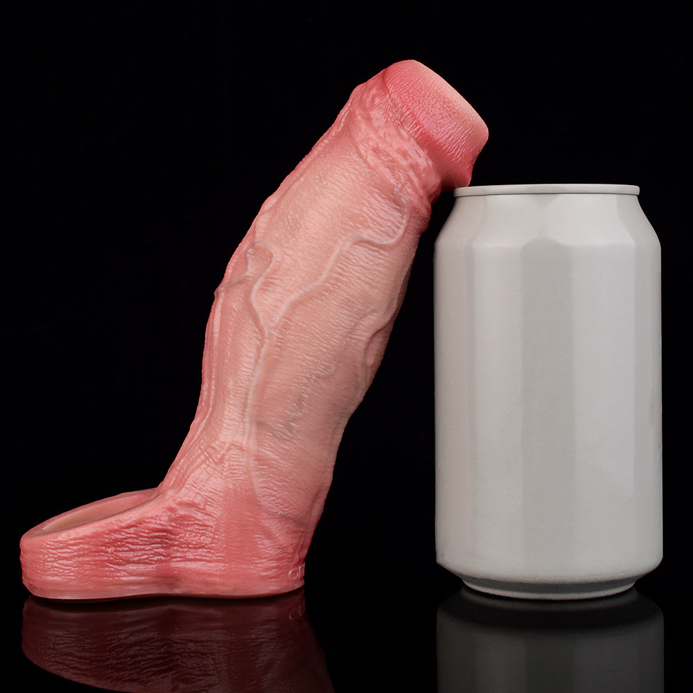 Pink penis sleeve with open end next to a white cylinder container.