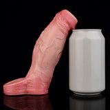 Pink penis sleeve with open end next to a white cylinder container.