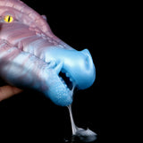 Close-up end view of blue-and-violet dragon fantasy sex toy, inner opening exposed