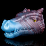 Side view of blue-and-violet dragon fantasy sex toy, textured scales and yellow eye