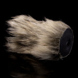 Cream faux-fur sleeve end with dark opening and visible round inner opening