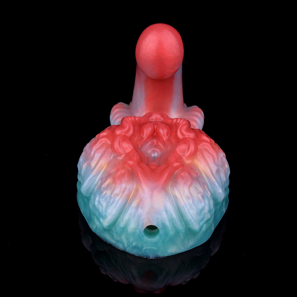Front view of red and blue swirled grinder sex toy with textured top detail