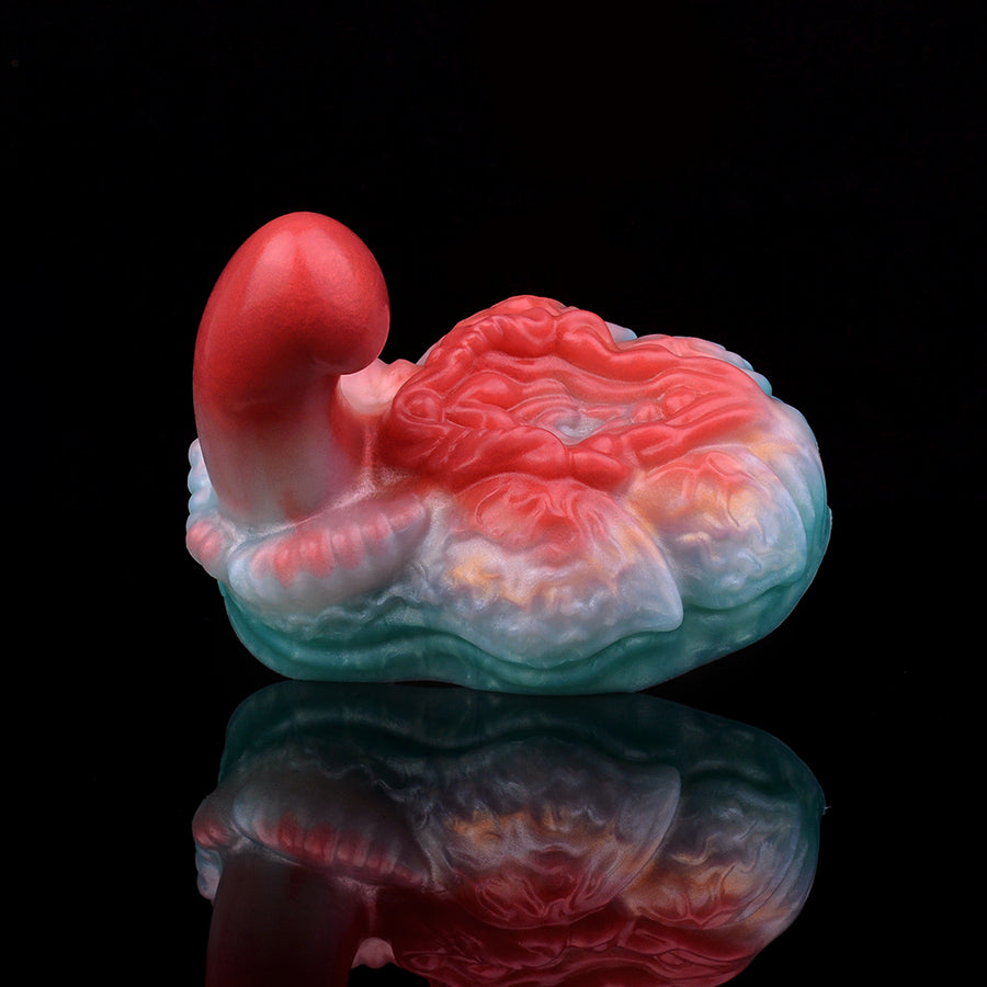 Swirled blue and pink silicone grinder toy with red dome handle tip and detailed top.