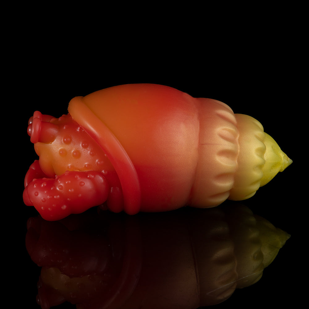 Orange and red squeeze toy crab with yellow tail, side view