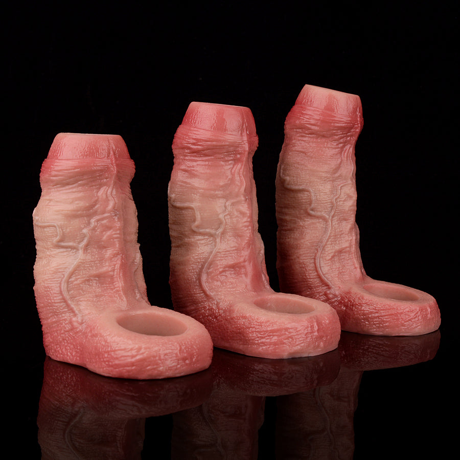 Three realistic penis sleeves in pink tones, standing together with open ends