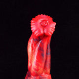 Red fantasy monster head detail on the curved dildo body