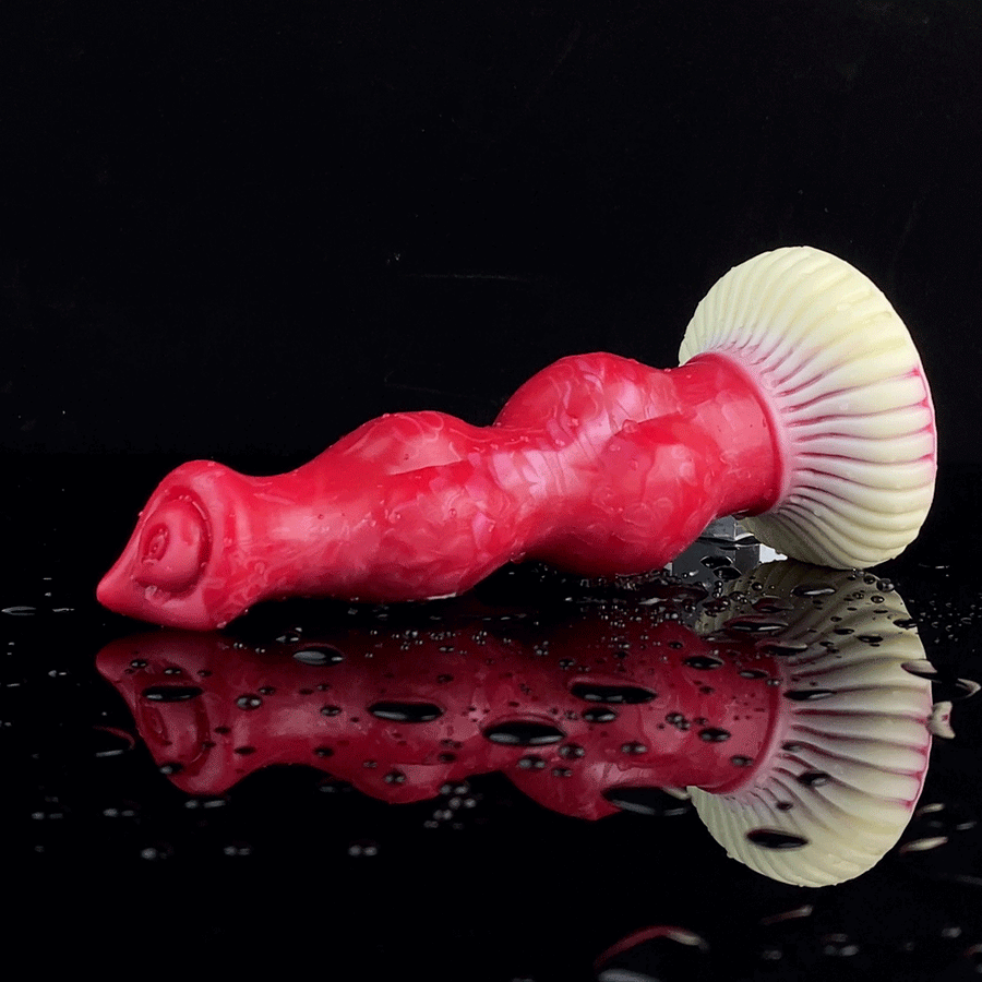 Red dog-shaped vibrator with wavy ribbed cream tail and rear