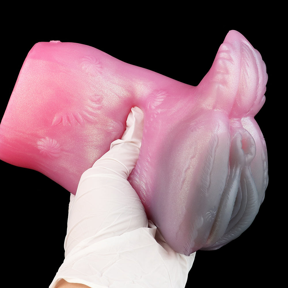 Pink deer-themed fleshlight held with white gloves, showing textured pattern and ear