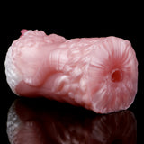 Dragon stroker end cap with circular opening, pink-white textured pattern.