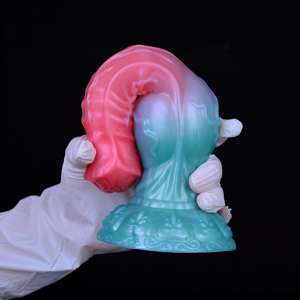 Close-up of alien werewolf dildo head with pink hood and teal muzzle, gloved hands