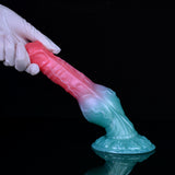 Fantasy alien werewolf dildo in hand, pink body with teal lower section