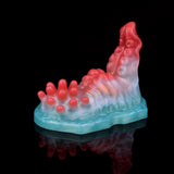 Red-and-blue strap-on grinder toy with raised bumps and wavy head