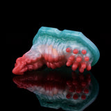 Red-and-blue grinder toy in side view with clustered nubs on one end