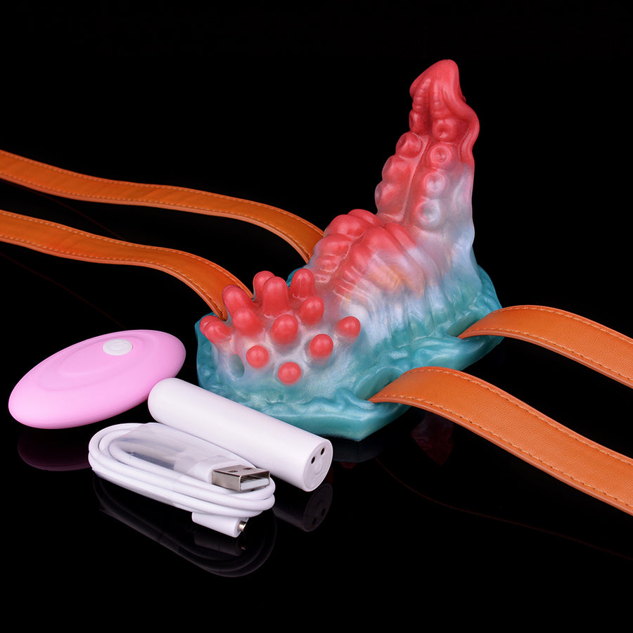 Adult strap-on grinder toy with orange straps, pastel blue/red body, pink and white controls