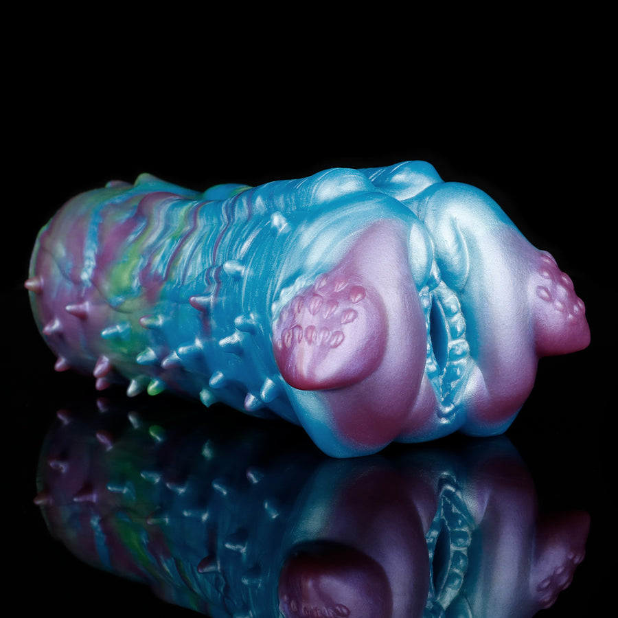 Dragon-themed one-hole masturbator, side angle with pink oval opening and studded texture
