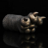 Bronze textured clawed hand curled, two visible spike tips and rounded knuckles