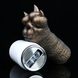 Bronze textured clawed hand beside a white container with metal top rim