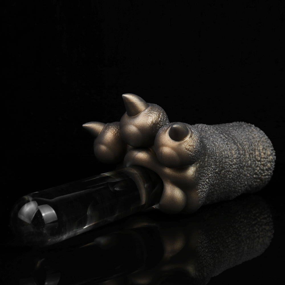 Bronze-colored textured hand figurine gripping a clear glass bottle