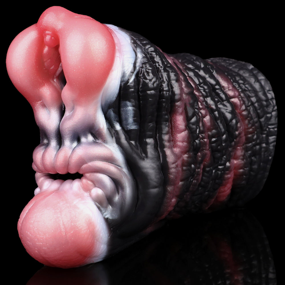 Elephant-pattern fleshlight masturbator angled close-up; black texture with pink openings