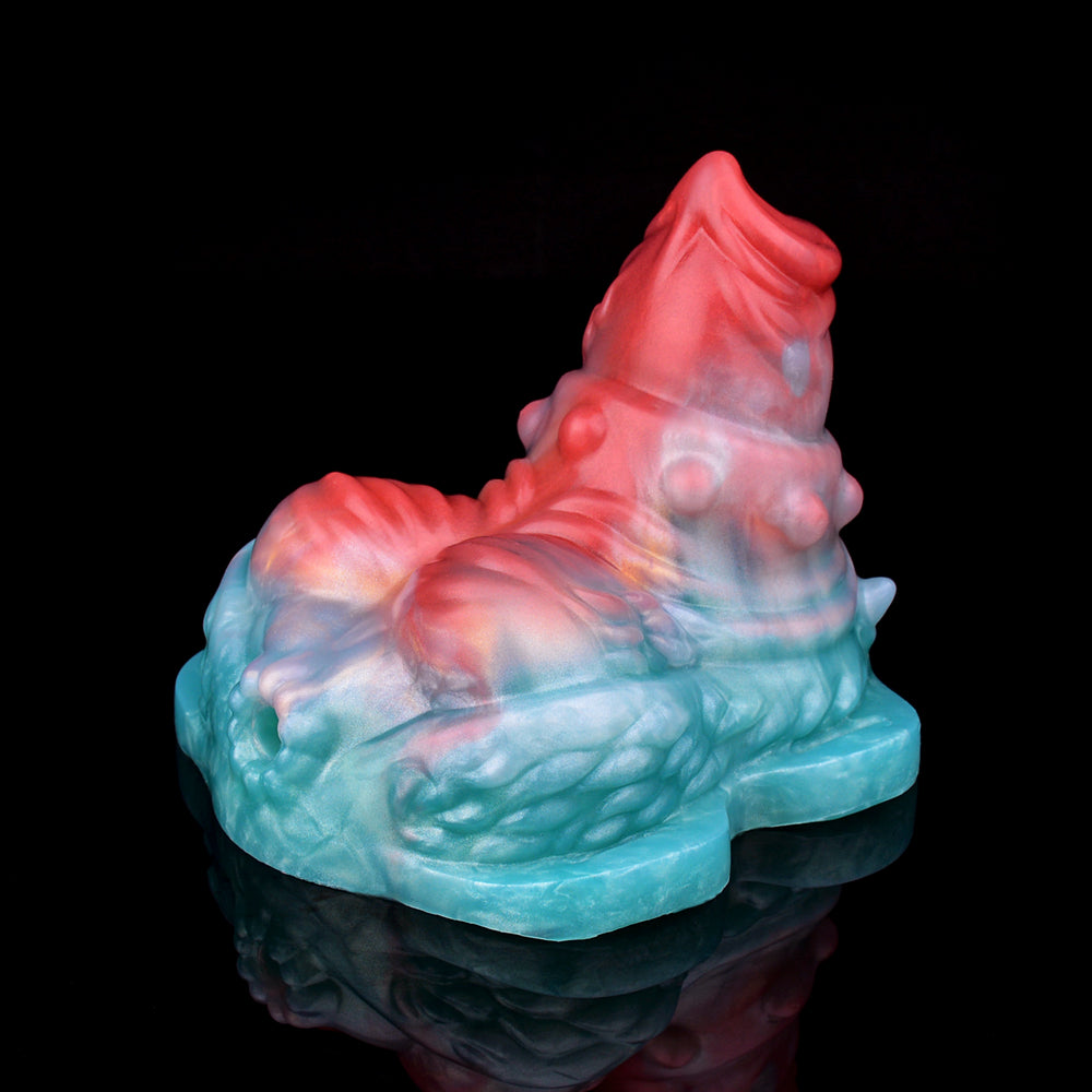 Translucent vibrating grinder sex toy, blue base with pink/red top ridges.