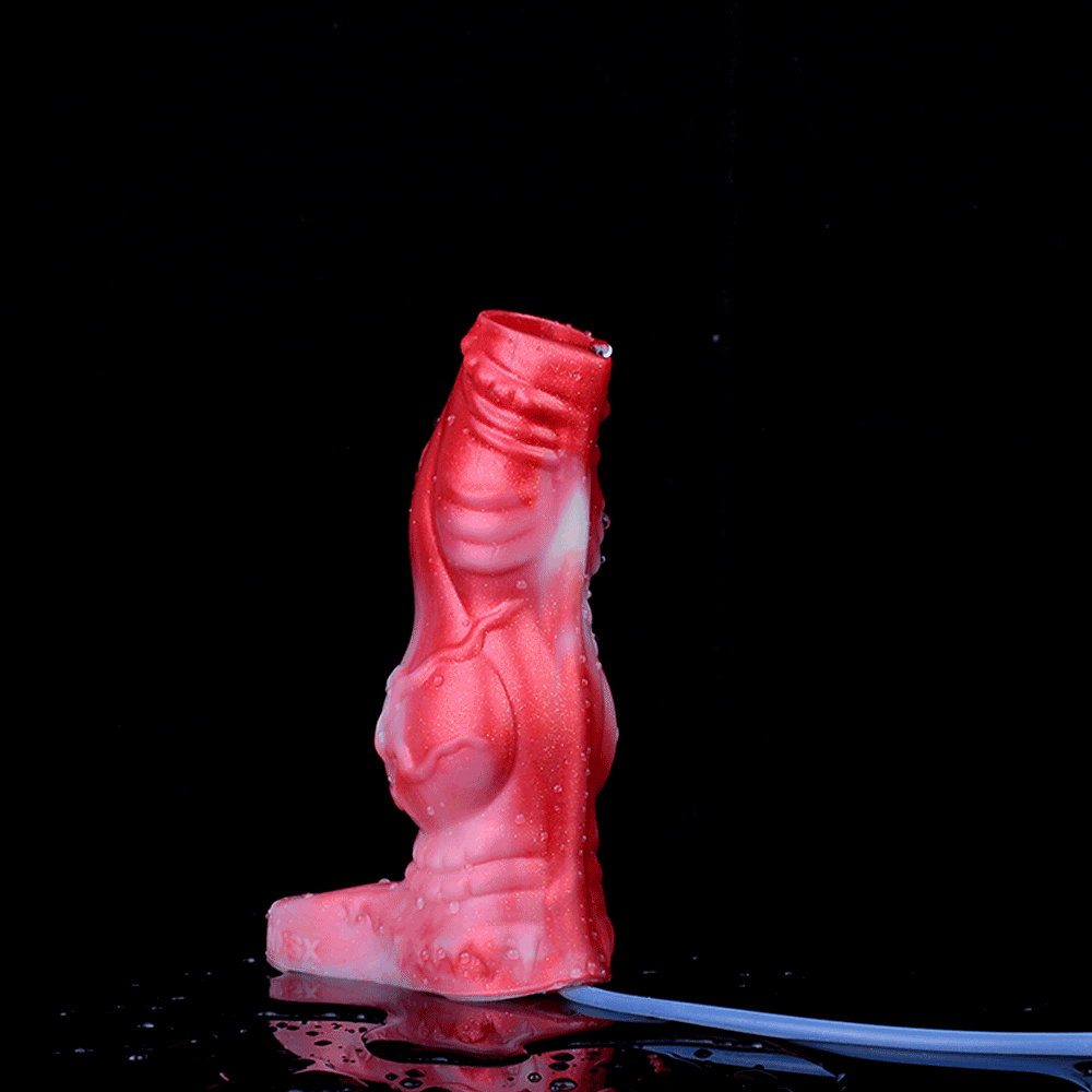Upright red silicone cock sleeve with open ring at base, squirting function