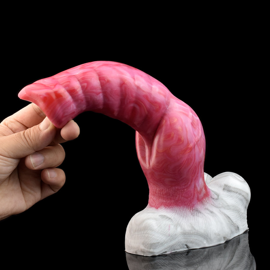 Vibrating wolf-shaped silicone dildo held in hand; pink curved body and white base