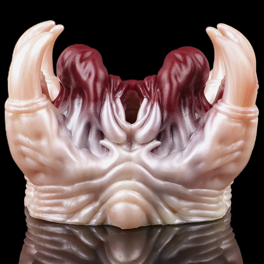 Facehugger-style fleshlight close-up with pale claws and dark red inner cavity