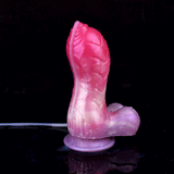 Pink unicorn squirting dildo standing upright on a round suction cup base.