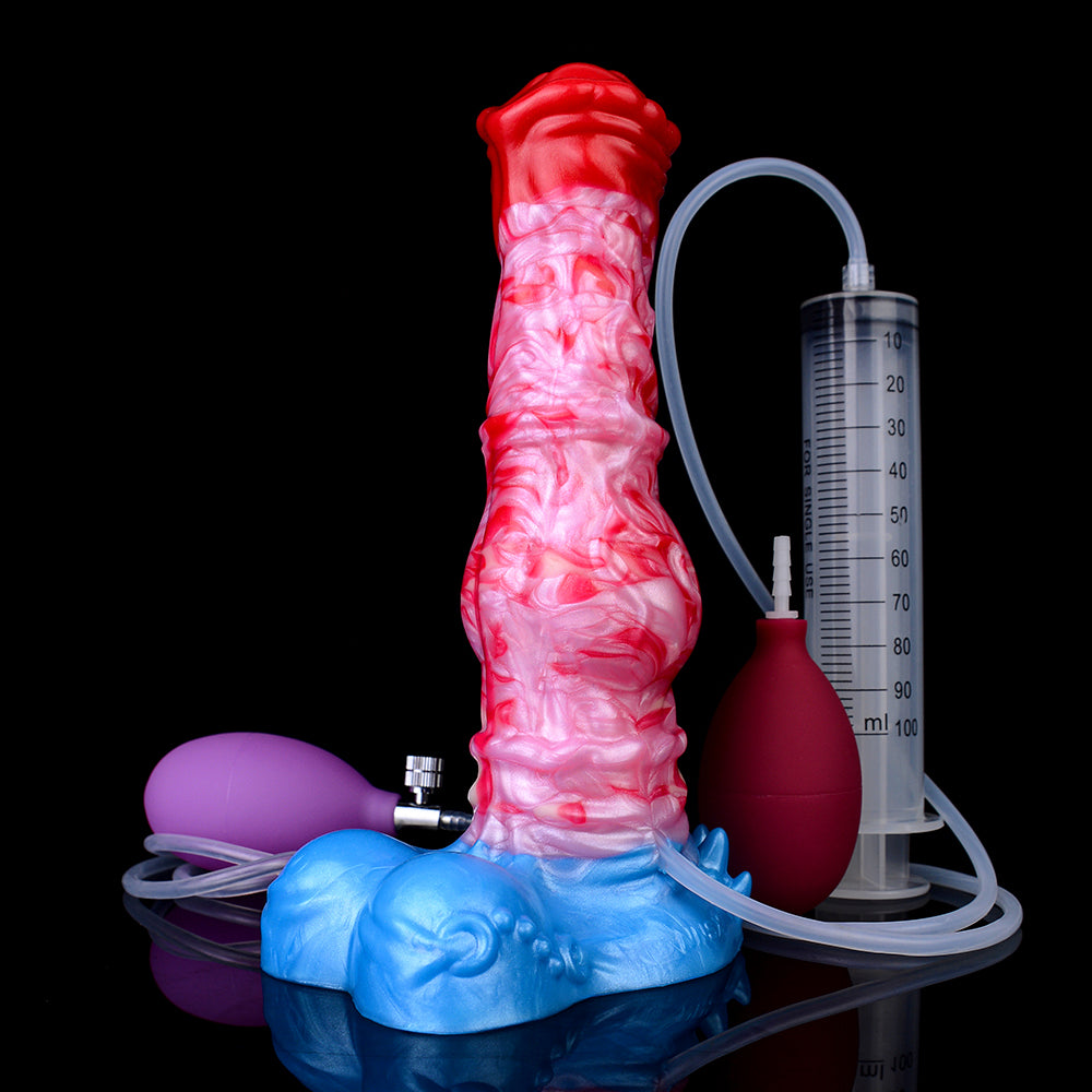 Pferde-Dildo mit rotem Kopf, rosa Strukturkörper und blauer Basis; Schlauch am Messzylinder