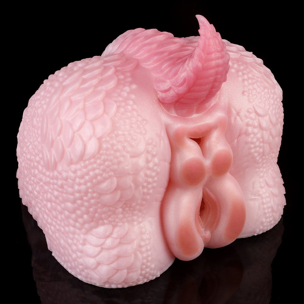Pink dragon-themed toy from side angle with textured body and molded nozzle