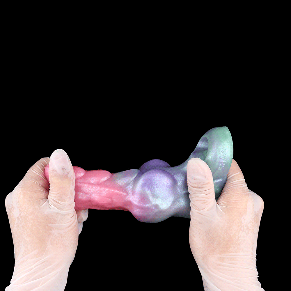Hands holding Flesh Shell knotted sleeve extender; pink/purple/teal gradient, ring opening