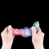Hands holding Flesh Shell knotted sleeve extender; pink/purple/teal gradient, ring opening
