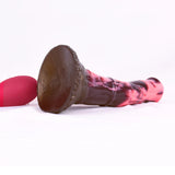 Textured brown base of marbled pink/dark horse dildo with red control bulb