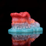 Back/side view of octopus-shaped insert with red top and teal base