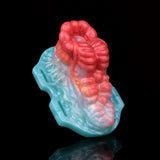 Angled view of octopus-shaped insert with red tentacles and teal base