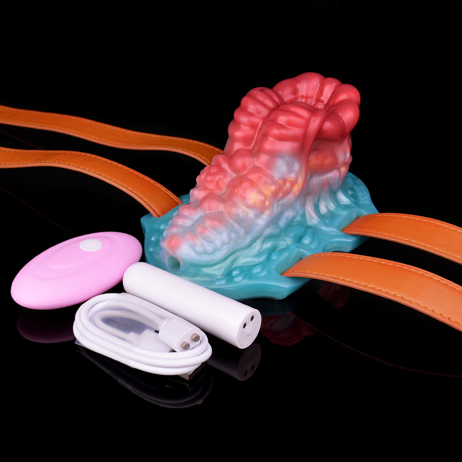 Octopus-themed sex toy with straps, pink remote, and white cable accessories.