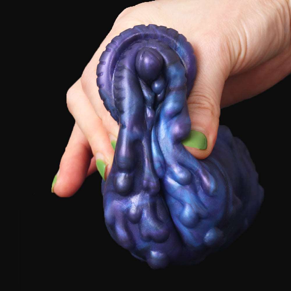 Purple suction-style tip with embossed animal texture, gripped by hand