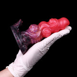 Alien anal plug, glossy pink body with iridescent purple swirl patterned base