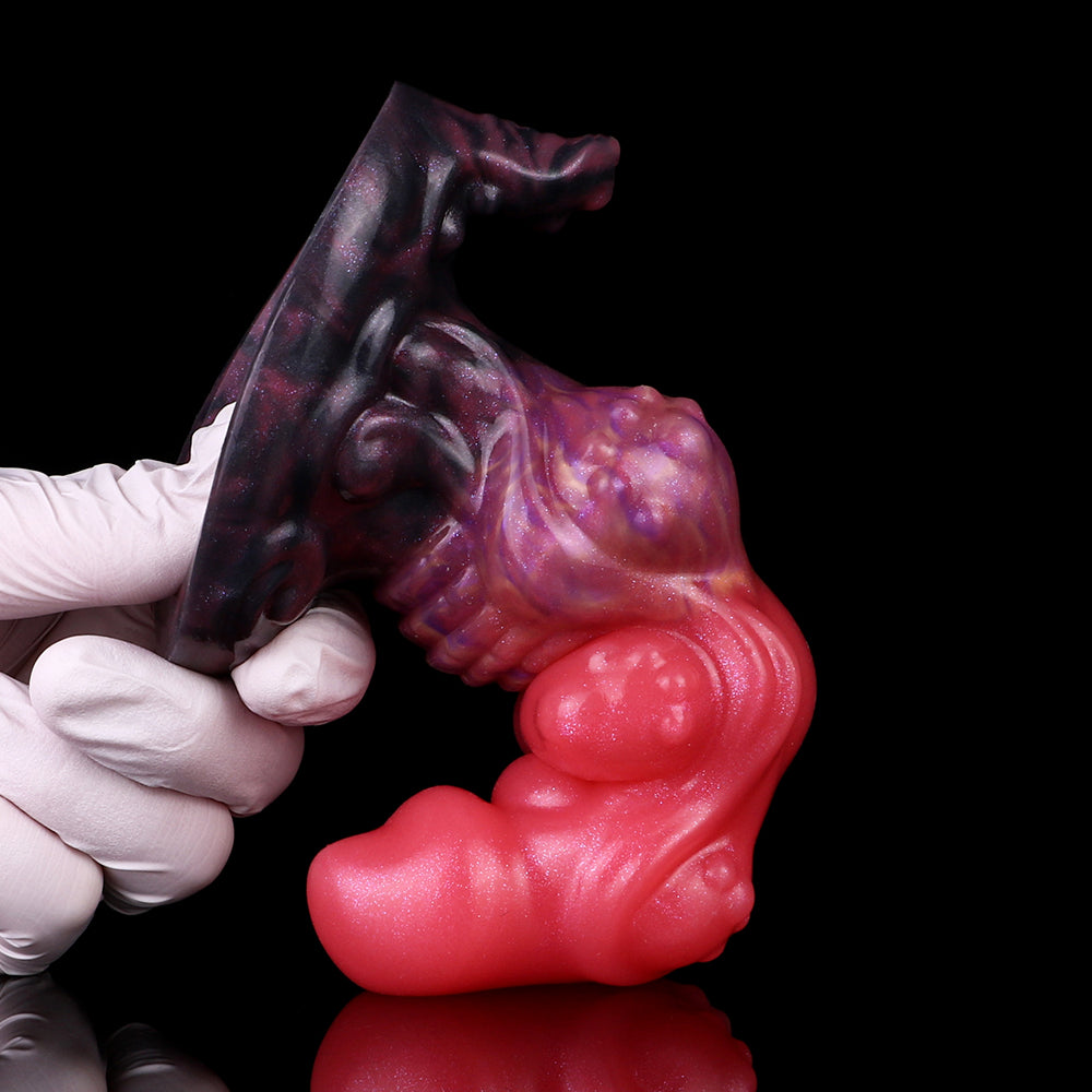 Glossy red alien anal plug with purple suction detail and textured fins