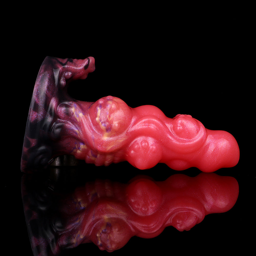 Alien anal plug angled view, glossy pink body with reflective purple swirl base