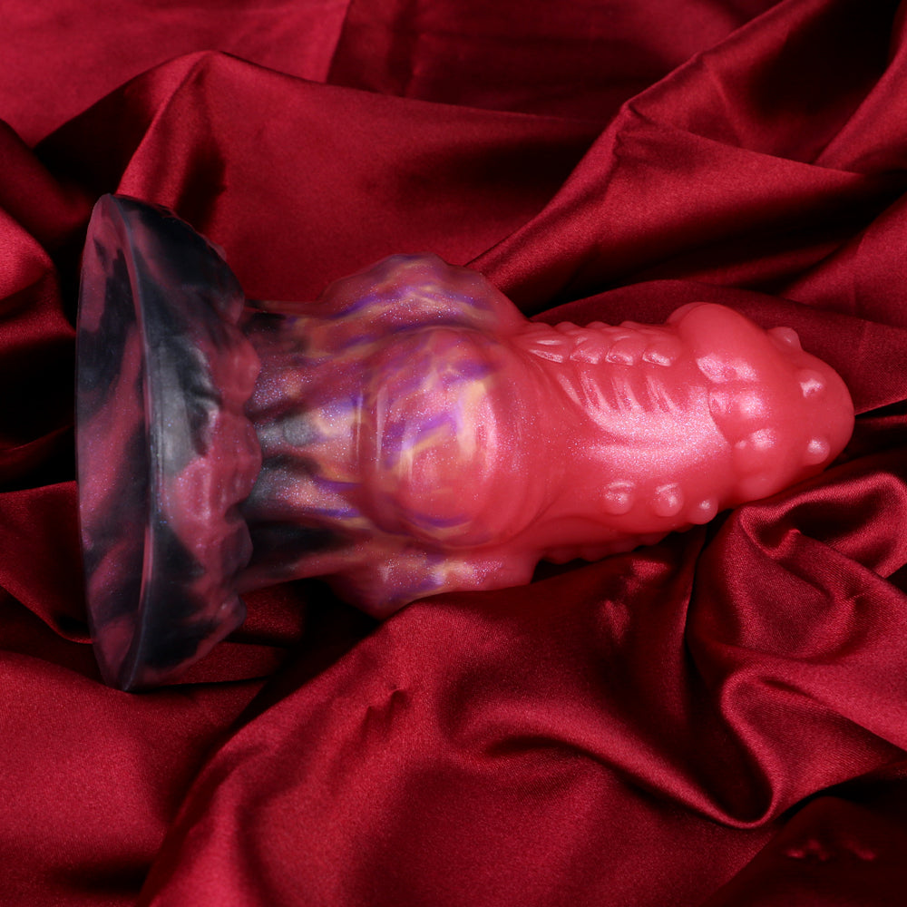 Wolf butt plug close-up: glossy pink and purple body with dark tail end