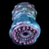 Front view of inner opening surrounded by pink nodules on a blue alien body
