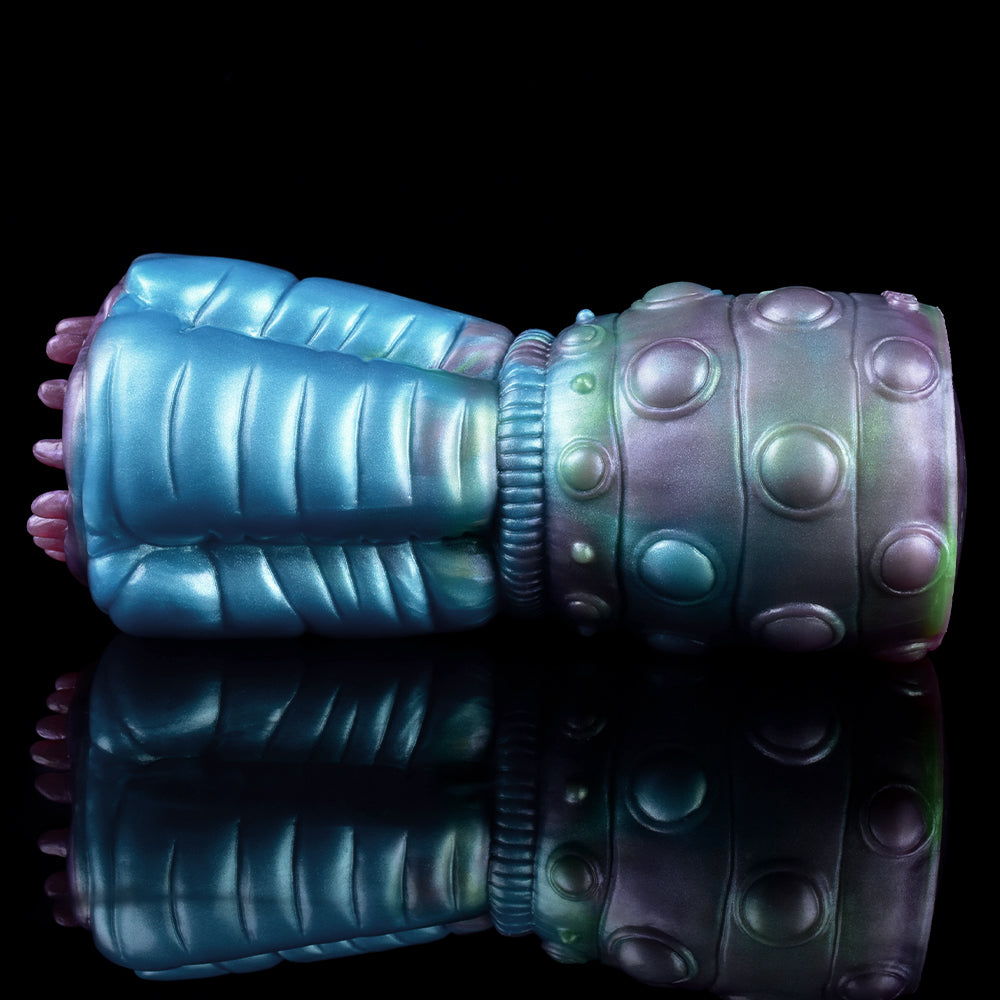Side view of blue alien stroker with textured grip, bulbous end cap, and dot details