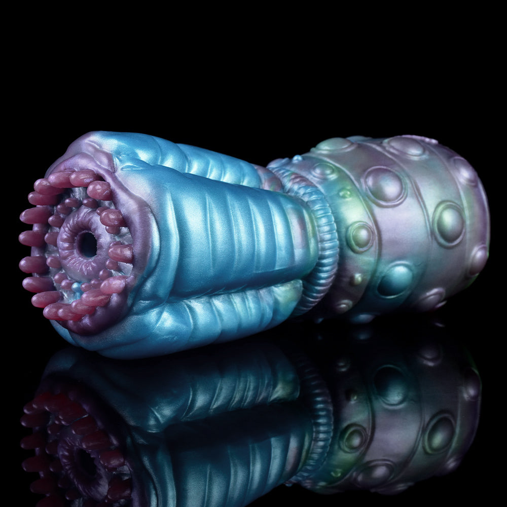 Angled view of blue alien stroker with ringed ribbed section and spotted metallic end