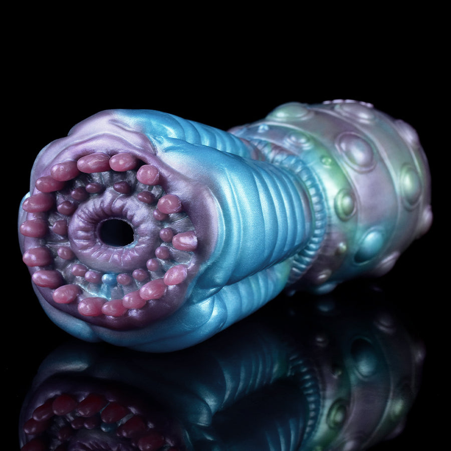 Close view of blue alien-styled masturbator end with pink beaded rim